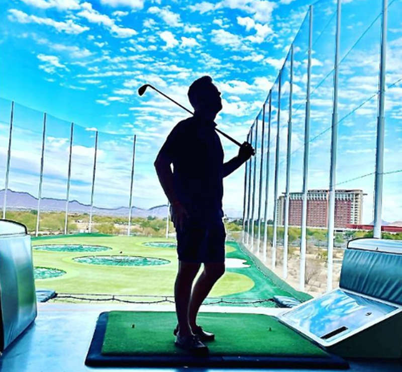silhouette of man at top golf