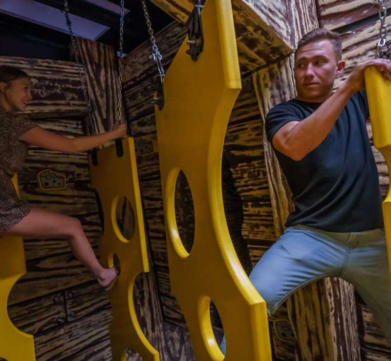 man and woman navigating obstacle course