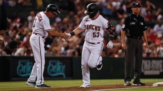 arizona diamondback baseball player running from third base to home plate
